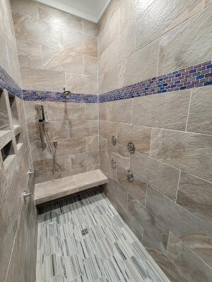 Custom tiled walk-in shower with new plumbing fixtures