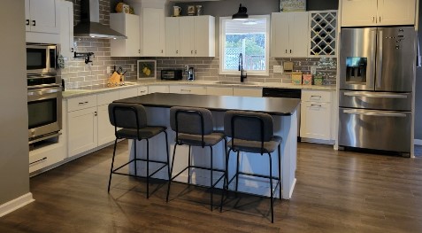 Remodeled kitchen with white cabinets and a large island